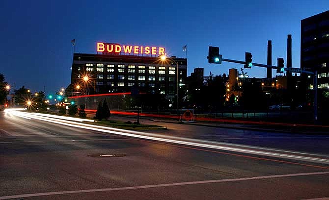 In this July 13, 2008 photo cars move near the Anheuser-Busch St. Louis brewery. The St. Louis brewer is being sued for gender discrimination by Francine Katz, who was the company's highest ranking female executive before her 2008 resignation.