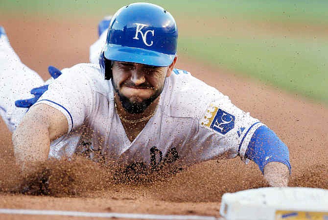 Kansas City Royals' Eric Hosmer slides into third base during the fourth inning of a baseball game against the Detroit Tigers in Kansas City, Mo., Saturday, May 3, 2014. Hosmer advanced on a wild pitch by Tigers starting pitcher Drew Smyly.