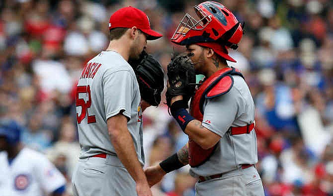 St. Louis Cardinals starting pitcher Michael Wacha, left, and catcher Yadier Molina talk during the fifth inning of a baseball game against the Chicago Cubs on Saturday, May 3, 2014, in Chicago. 