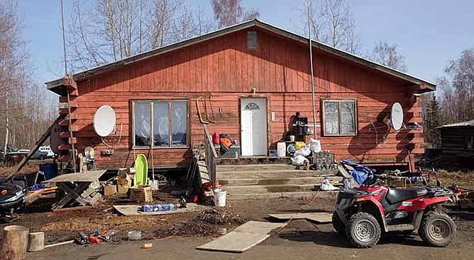 This Friday, May 2, 2014 photo shows the house at the scene of the fatal shooting of Alaska State Trooper Sergeant Patrick "Scott" Johnson and Trooper Gabriel "Gabe" Rich in the village of Tanana, Alaska.