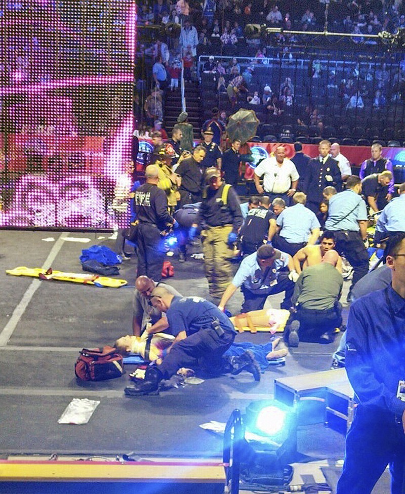 First responders tend to the injured performers.