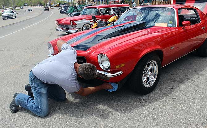 Rich Shoemake of Patton, Mo., puts some finishing touches on his 1973 Chevrolet Z-28 Camaro, one of the many cars on display at the Magic Dragon Street Meet Nationals.