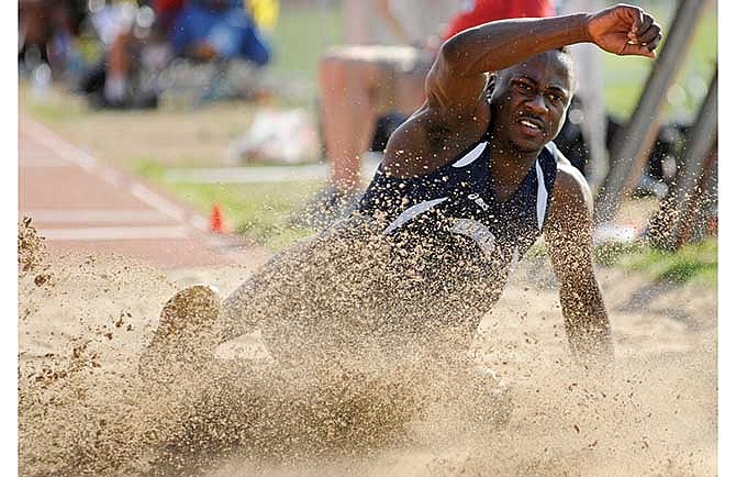 Orneldo Thomas of Lincoln splashes in the pit during the men's long jump Saturday at the MIAA Outdoor Track and Field Championships at Dwight T. Reed Stadium in Jefferson City.