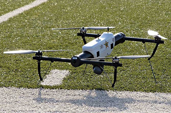 In this May 14, 2013 file photo, one of several small drones designed for use by law enforcement and first responders is shown at University of North Dakota in Grand Forks, N.D. Thirteen leading news organizations are challenging the Federal Aviation Administration's ban on journalists' use of drones, saying it violates First Amendment protection for news gathering. The organizations, including The Associated Press, filed a brief with the National Transportation Safety Board Tuesday, May 6 in support of aerial photographer Raphael Pirker.