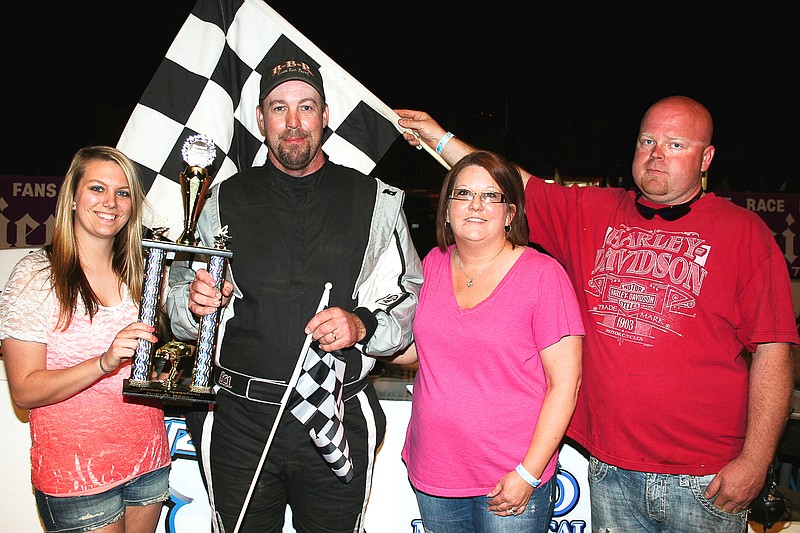 John Clancy, Jr., California, claims the Street Stock trophy Sunday night at the Double-X Speedway.Â Clancy is joined by his wife Kim, Double-X Trophy Girl Kelsey Brauner. at left, and Double-X Director of Competition Chris Winter.

