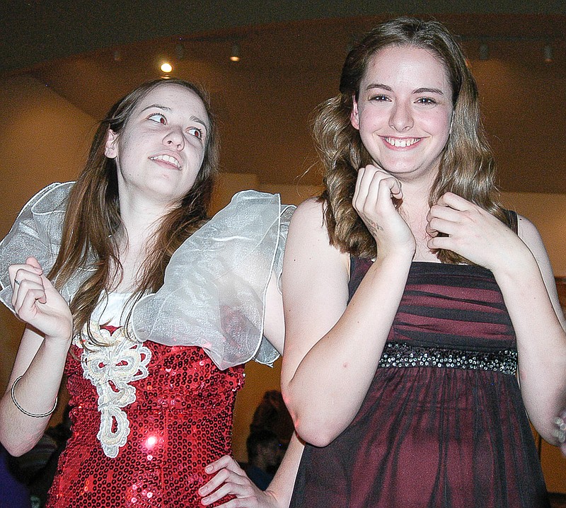 During the mystery dinner theater Friday, drama queen Angelina (Angela McNay), left, and classmate beauty queen Elaine Bluster (Alison Hawley) speak to the diners at the event about whether Elaine should divorce Heath.