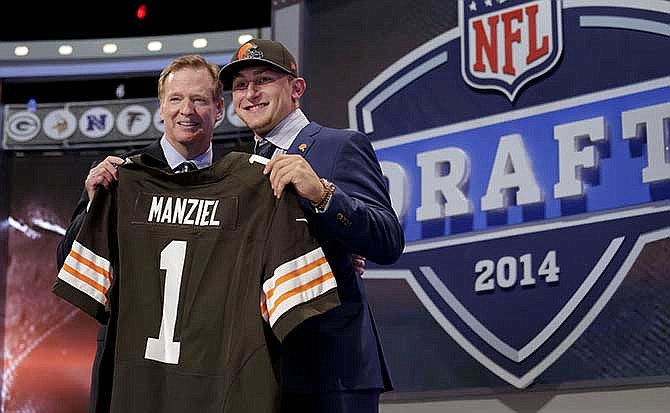 Texas A&M quarterback Johnny Manziel poses with NFL commissioner Roger Goodell after being selected by the Cleveland Browns as the 22nd pick in the first round of the 2014 NFL Draft, Thursday, May 8, 2014, in New York. 