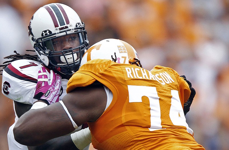 In this Oct. 19, 2013, file photo, South Carolina defensive end Jadeveon Clowney (7) rushes against Tennessee offensive linesman Antonio Richardson (74) during a game in Knoxville, Tenn. The Texans hold the No. 1 overall pick in a draft in which Clowney is widely considered the best player available.