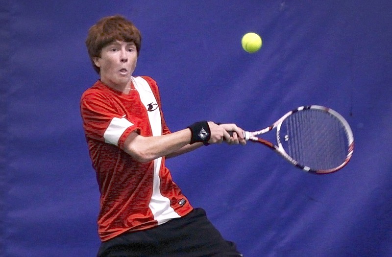 Dane Biesemeyer of Jefferson City makes a return during a doubles match Thursday against Helias at the YMCA Firley Center