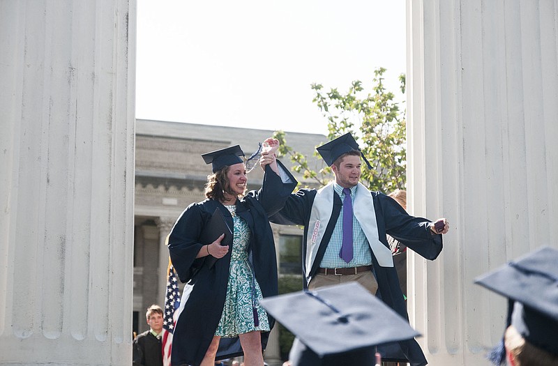 Westminster College graduates Kayla Foust of Fulton and Joe Garwood of New Bloomfield raise their arms just after Garwood proposed to Foust, his girlfriend of five years. They first met at Fulton High School when they took the ACT test.