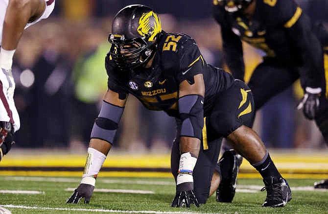 In this Nov. 20, 2013, file photo, Missouri defensive lineman Michael Sam takes up his position during the first half of an NCAA college football game against Texas A&M in Columbia, Mo. 
