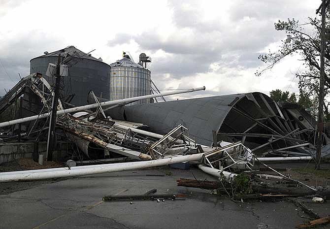 A grain elevator lies toppled after severe weather passed through Orrick, Mo., northeast of Kansas City, Mo., on Saturday afternoon, May 10, 2014. Heavy storms spawning at least one tornado hit northwest Missouri, damaging homes and power lines. No injuries were immediately reported.