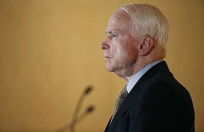 Sen. John McCain listens to complaints from veterans during a forum with veterans on Friday, May 9, 2014, in Phoenix. McCain was discussing lapses in care at the Phoenix Veterans Affairs hospital that prompted a national review of operations around the country. 