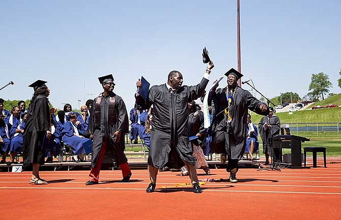 Lincoln University graduates dance after leaving the stage Saturday, May 10, 2014, during the school's annual commencement ceremony at Dwight T. Reed Stadium in Jefferson City.