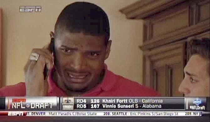 In this image taken from video, Missouri defensive end Michael Sam cries as he talks on a mobile phone at a draft party in San Diego, after he was selected in the seventh round, 249th overall, by the St. Louis Rams in the NFL draft Saturday, May 10, 2014. The Southeastern Conference defensive player of the year last season came out as gay in media interviews this year.