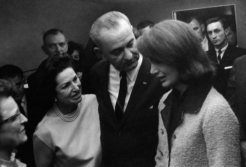In this Nov. 22, 1963, file photo, provided by the White House, Thomas "Lem" Johns, background right, stands behind President Lyndon B. Johnson and his wife, Lady Bird, wearing a necklace, as they console Jacqueline Kennedy, right, moments after Johnson was administered the oath of office in the cabin of the presidential plane at Love Field in Dallas. Johns, a former secret service agent present during the assassination of President John F. Kennedy and swearing in of Johnson, has died. He was 88. Grandson Mike Johns said the former secret service agent died Saturday, May 10, 2014, in Alabama. (AP Photo/White House/Cecil Stoughton, File)