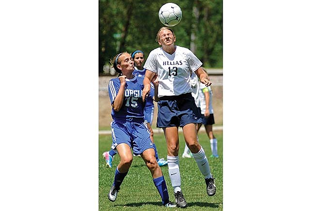Kaysie Scheuler of Helias goes up to head a pass away from St. Francis Borgia's Katherine Mudd during Saturday's game at the 179 Soccer Park in Jefferson City.