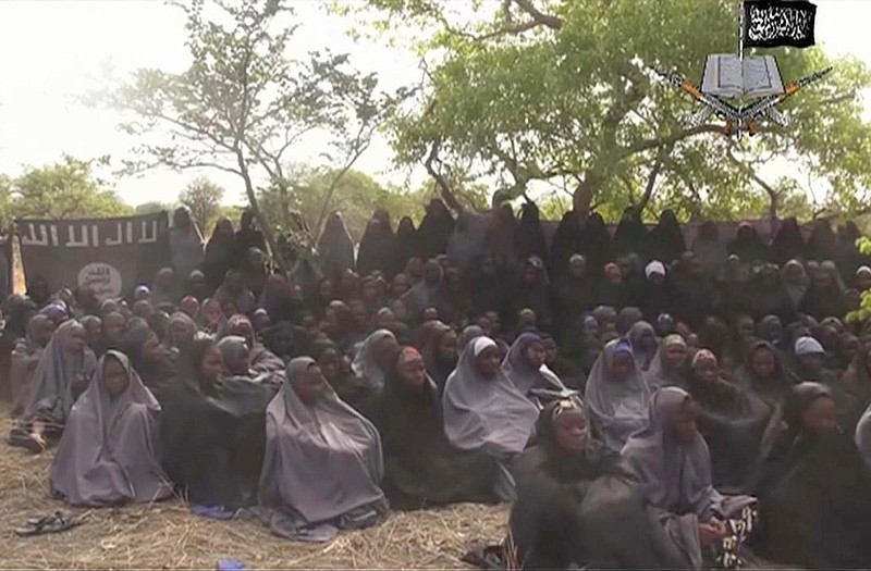 In this  photo taken from video by Nigeria's Boko Haram terrorist network shows the alleged missing girls abducted from the northeastern town of Chibok.