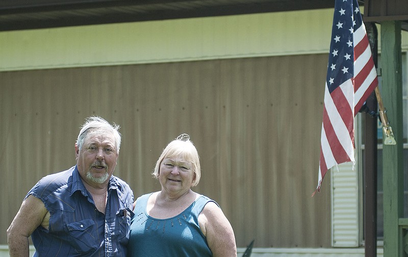 Phillip and Karen Baumgarth of Portland stand outside their home for a photo Friday. The Baumgarths recently donated more than $400 to the lunch debt of 57 students in South Callaway R-II Schools.