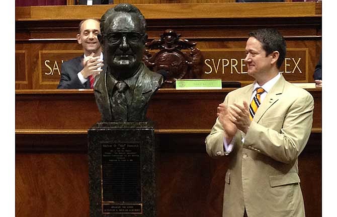 Missouri House Speaker Tim Jones, right, unveils a bronze bust of tax-limit supporter Mel Hancock during a ceremony Wednesday, May 14, 2014, at the state Capitol in Jefferson City, Mo. Hancock led an effort to approve a state constitutional amendment in 1980 limiting state revenues and local taxes.