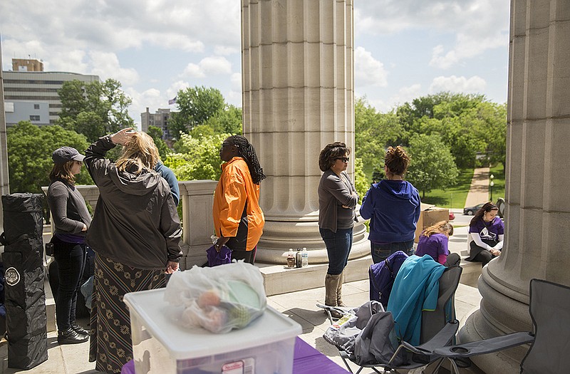 Volunteers from the Women's Filibuster talk during cleanup after staging a 72-hour live streaming filibuster on the south steps of the Capitol. 