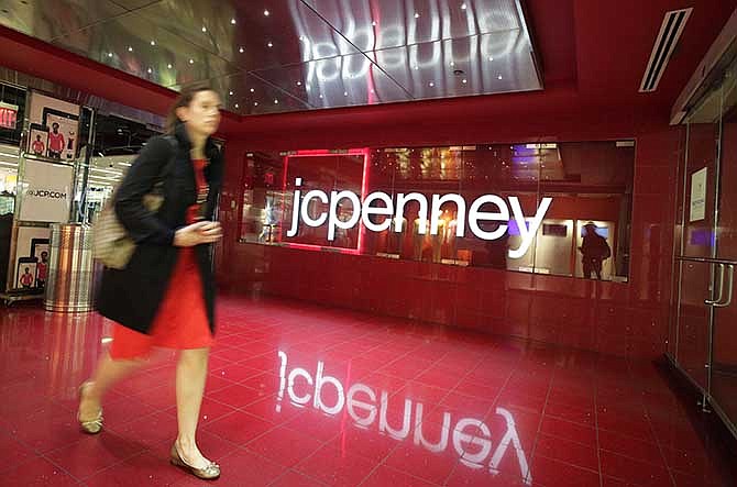 In this April 9, 2013 file photo, a customer leaves a JC Penney store in New York. 