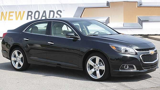 In this May 31, 2013 file photo, the 2014 Chevrolet Malibu is unveiled on Belle Isle in Detroit. General Motors is recalling more than 140,000 2014 Chevrolet Malibu midsize cars to fix a problem with the power-assisted brakes. The recall affects models with 2.5-liter four-cylinder engines and stop-start technology that shuts off the engine at red lights. 