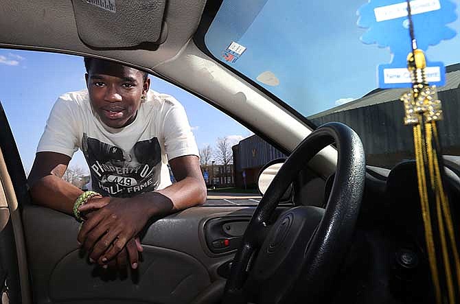 A graduation tassel hangs from the rearview mirror of transfer student Shaheed Whitfield, 17, of Normandy, Mo., on April 18, 2014, in Hazelwood, Mo. Whitfield drives to Hazelwood Central to attend high school where he's scheduled to graduate on May 31. The Missouri Legislature passed legislation Thursday, May 15 that overhauls a student transfer law requiring struggling school districts pay for students to attend better-performing nearby schools. (AP Photo/St. Louis Post-Dispatch, Stephanie S. Cordle)