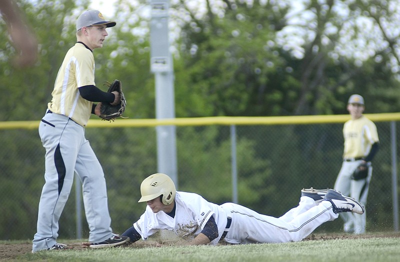 Helias' Todd Buschjost slides safely into second base during Thursday's game with Sedalia Smith-Cotton at the American Legion Sports Complex.