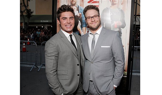 Zac Efron, left, and Seth Rogen arrive at the world premiere of "Neighbors" at the Regency Village Theatre on Monday, April 28, 2014, in Los Angeles. 