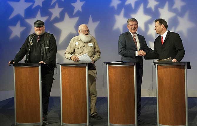 In this image provided by Idaho Public Television, Idaho Gov. Butch Otter, second right, appears on stage with Republican gubernatorial hopefuls, from left, Harley Brown, Walt Bayes, and state Sen. Russ Fulcher, at a debate Thursday May 15, 2014 in Boise, Idaho. Brown and Bayes stole the show from Otter and Fulcher, using their time to discuss Armageddon, discrimination against motorcycle clubs and problems with political correctness. 