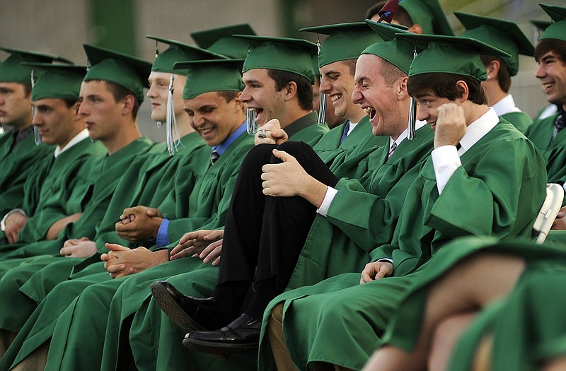 Ben Campbell, at right with a Superman on cap, enjoys a good laugh with his classmates as Blair Oaks guidance counselor Jill Shanley reads out a list of accomplishments and memorable moments by his class.
