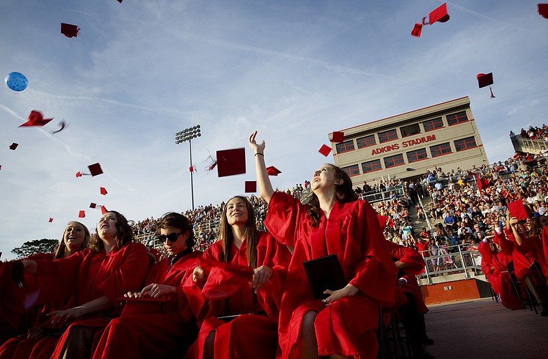 Graduates from Jefferson City High School throw their caps in the air as the graduation ceremony comes to a close Sunday evening at Adkins Stadium.