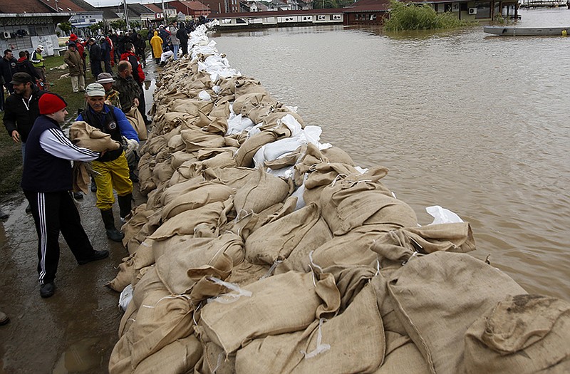People build a dam made up of sandbags by the bank of the Sava river west of Belgrade, Serbia.