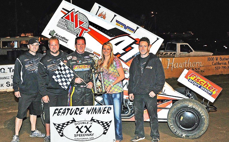 Jason Johnson, Rocky Mount, won the feature event in the 360 Winged Sprint division Sunday at the Double-X Speedway, California. Johnson is shown with crew members and Double-X Trophy Girl Kelsey Brauner, California. 