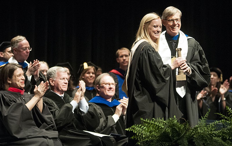 Elise Bartley, Westminster College assistant professor of accounting, accepts the Patricia Klein Liebling Parents Association Faculty Award from Westminster President Barney Forsythe during commencement on May 10. Students from the Westminster College 2014 graduating class voted for Bartley to be the recipient.