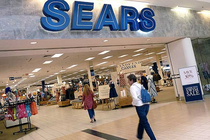 In this Monday, May 14, 2012, file photo, shoppers walk into Sears in Peabody, Mass.
