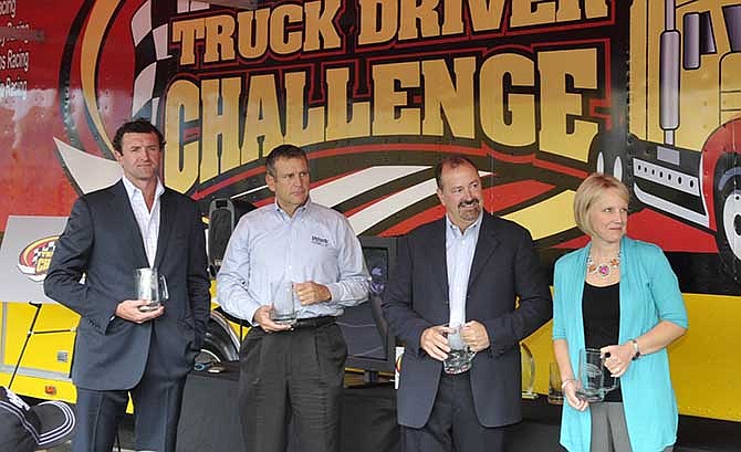 In this file photo taken Oct. 10, 2011, Pilot Flying J executives J.W. Johnson, from left, Scott "Scooter" Wombold, Mark Hazelwood, and Wendy Hamilton attend an appreciation breakfast for the Transport Drivers of Motorsports Association and Pilot Flying J Truck Driver Challenge in Knoxville, Tenn. More than a year after FBI agents raided the Tennessee headquarters of the huge truck-stop chain owned by Cleveland Browns' owner and Tennessee's governor, Pilot Flying J is cleaning house. Hazelwood, Pilot president, and Wombold, vice president of national accounts, left the company Monday, May 19, 2014, with Haslam sending a company-wide email thanking Hazelwood for his service but saying nothing about why or how he was leaving. Tuesday saw the departure of five more members of the sales team. 