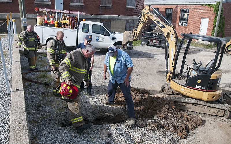 The Fulton Fire Department and a public works employee worked on this leaking gas line Friday afternoon.