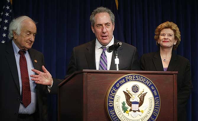 U.S. Trade Representative Mike Froman, Rep. Sander Levin, D-Mich., and Sen. Debbie Stabenow, D-Mich., speak to reporters regarding a World Trade Organization case involving China and the U.S. auto industry, Friday, May 23, 2014.