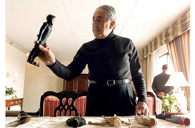 In this Jan. 30, 2003 file photo, G.I. Joe creator Don Levine holds up his original scuba diver G.I. Joe as other original prototypes lie on top of a table in Providence, R.I. Levine died of cancer early Thursday, May 22, 2014, at Home & Hospice Care of Rhode Island, said his wife, Nan. He was 86. 