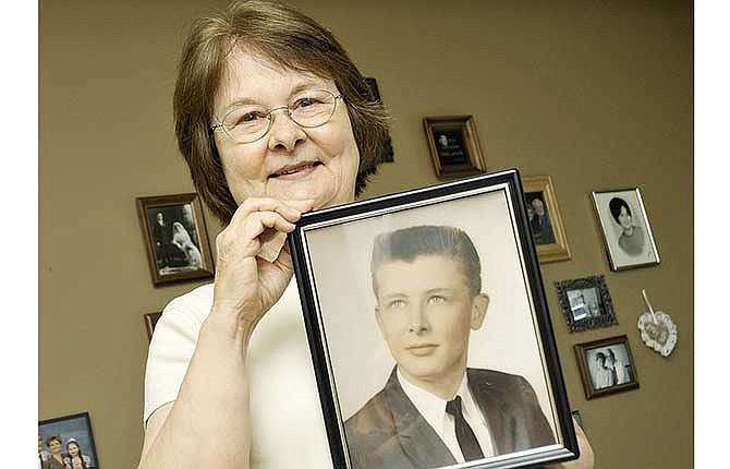 Jeanie Hasenbeck holds a photograph of her brother, Paul Hasenbeck, who is listed as Missing In Action (MIA) in Vietnam.