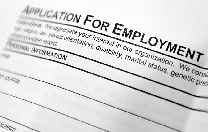 This April 22, 2014, photo shows an employment application form on a table during a job fair in Hudson, N.Y. 