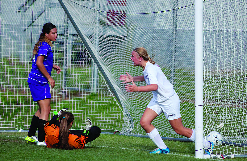 Jefferson City's Tayler LePage (right) celebrates after scoring the first goal of Tuesday's Class 3 sectional game with Hickman at the 179 Soccer Park. Looking on for the Kewpies are Adison Capell (left) and goalkeeper Emily Miller.