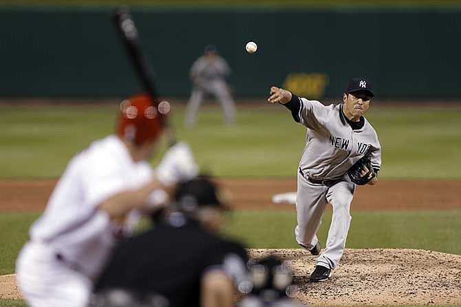 New York Yankees starting pitcher Hiroki Kuroda throws during the fourth inning of a baseball game against the St. Louis Cardinals on Wednesday, May 28, 2014, in St. Louis.