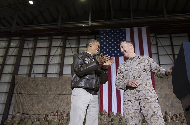 President Barack Obama, left, is introduced by Marine Gen. Joseph Dunford, commander of the US-led International Security Assistance Force (ISAF) after arriving for a troop rally during an unannounced visit to Bagram Air Field on Sunday.