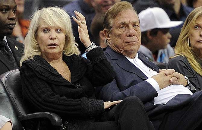 In this Nov. 12, 2010, file photo, Shelly Sterling sits with her husband, Donald Sterling, right, during the Los Angeles Clippers' NBA basketball game against the Detroit Pistons in Los Angeles. 