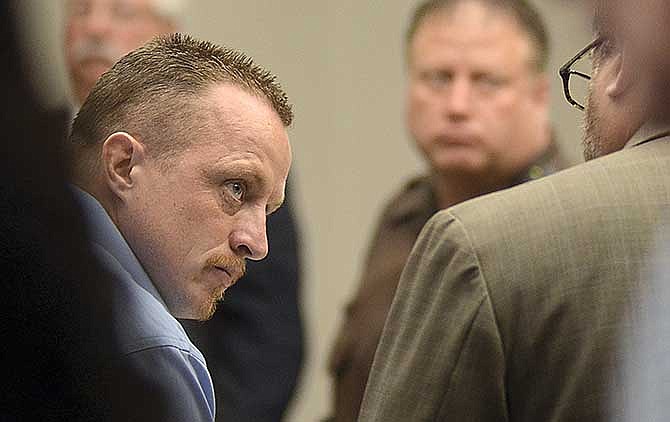 Nicholas Sheley, left, speaks with his attorney Jeremy Karlin during a break in his murder trial Wednesday, May 28, 2014, in Rock Island, Ill. Sheley was convicted the following day in the slayings of two men, a woman and a toddler who were beaten to death with a hammer in a Rock Falls apartment in June 2008. Their slayings are among eight that authorities say Sheley committed in Illinois and Missouri over seven days. (AP Photo/The Telegraph, Alex T. Paschal)
