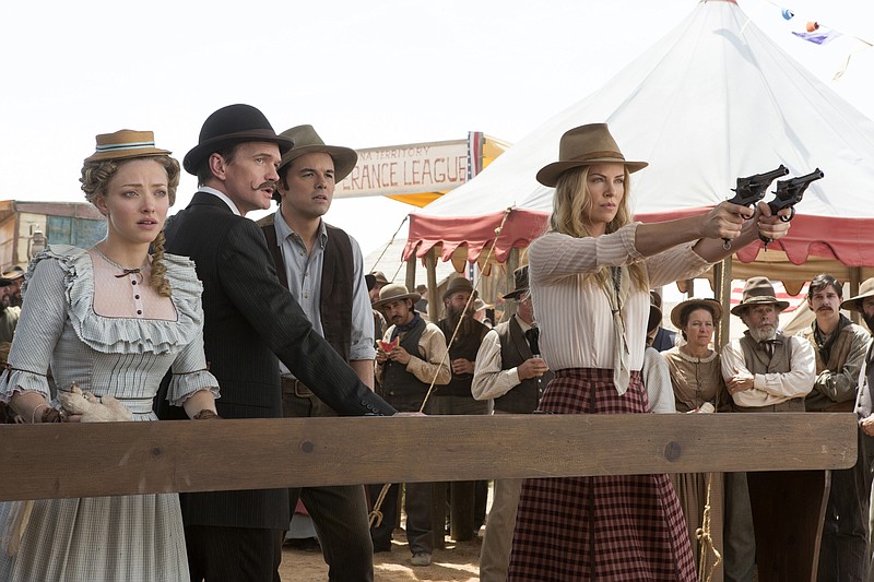 This image released by Universal Pictures shows, from left, Amanda Seyfried, Neil Patrick Harris, Seth MacFarlane and Charlize Theron in a scene from "A Million Ways to Die in the West."