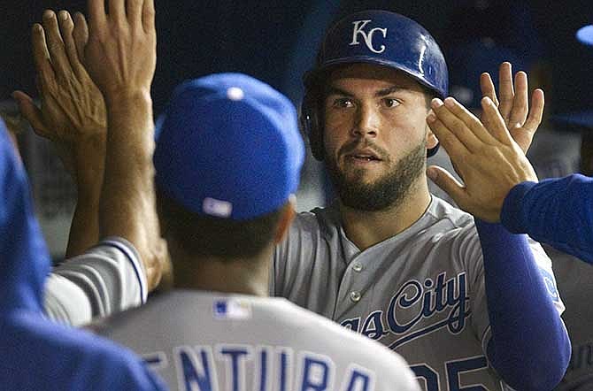 Kansas City Royals' Eric Hosmer, center, is congratulated in the dugout after scoring on a ground rule double by teammate Alex Gordon during tjhe fourth inning of a baseball game against the Toronto Blue Jays in Toronto, Thursday, May 29, 2014.